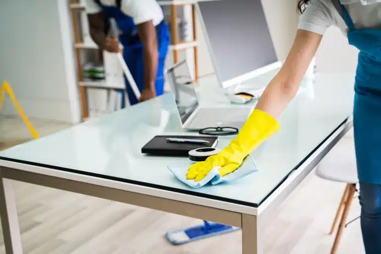 Office desk being disinfected by a CleansePro cleaner using eco-friendly products