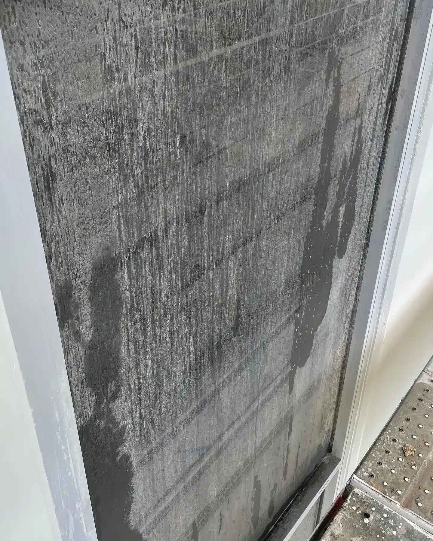 Before image of a Gold Coast window covered in builders residue before CleansePro window cleaning